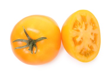 Photo of Whole and cut yellow tomatoes isolated on white, top view