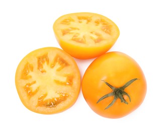 Photo of Whole and cut yellow tomatoes isolated on white, top view