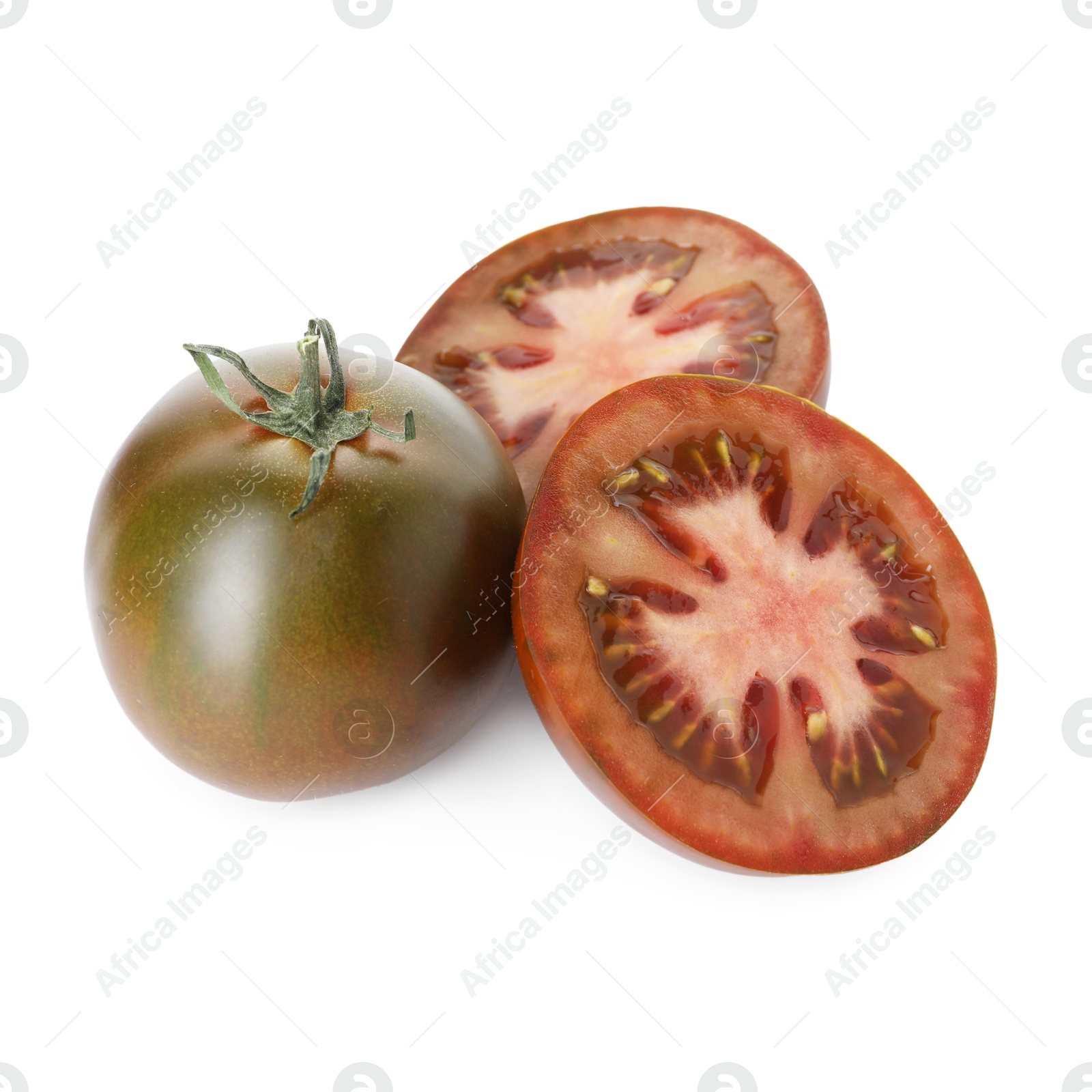 Whole and cut brown tomatoes isolated on white Photo of Whole and cut brown tomatoes isolated on white