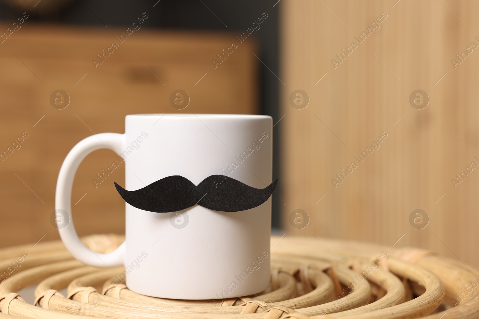 Happy Father's Day. Cup with paper moustache on coffee table indoors, closeup. Space for text Photo of Happy Father's Day. Cup with paper moustache on coffee table indoors, closeup. Space for text