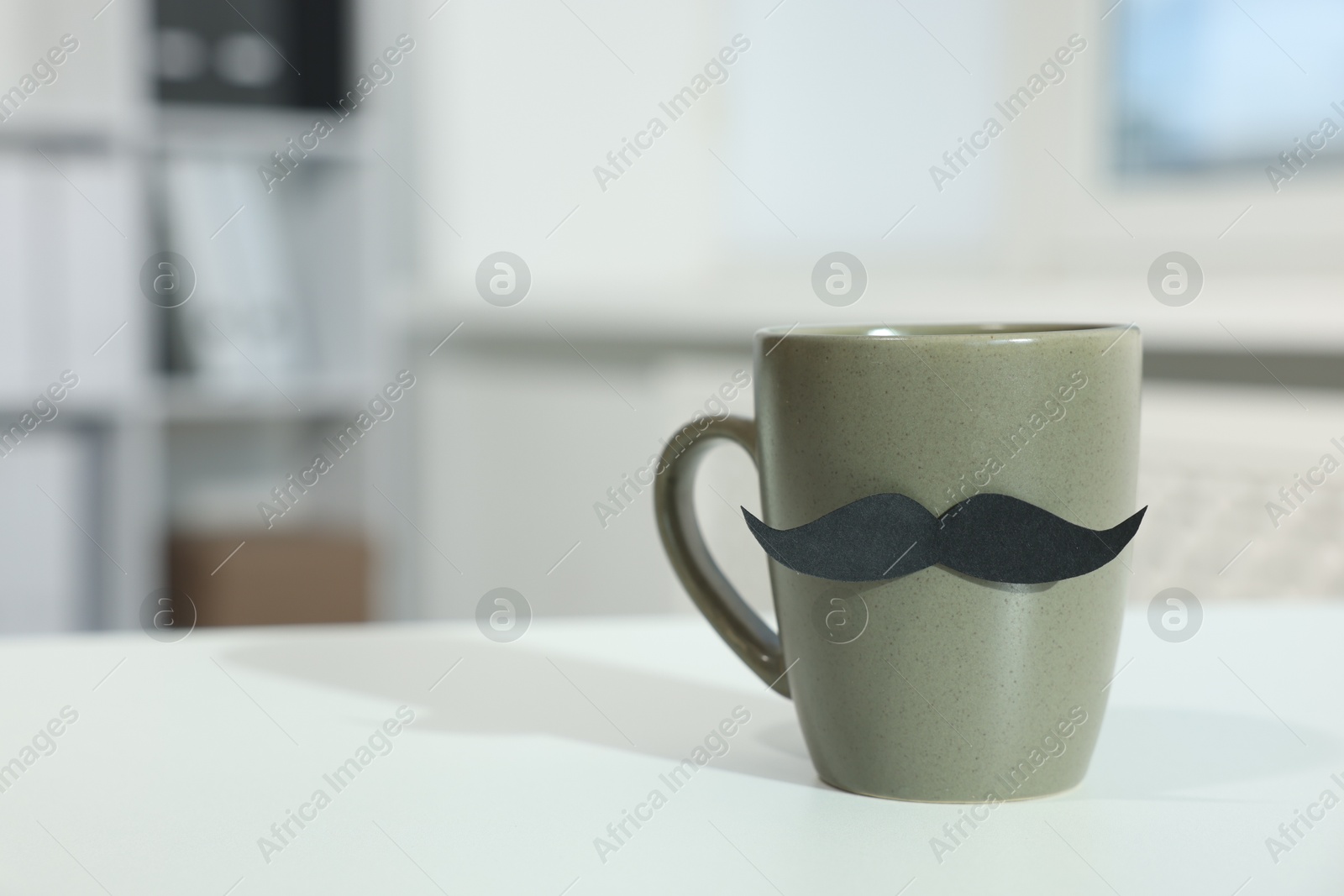 Happy Father's Day. Cup with paper moustache on white table indoors, closeup. Space for text Photo of Happy Father's Day. Cup with paper moustache on white table indoors, closeup. Space for text