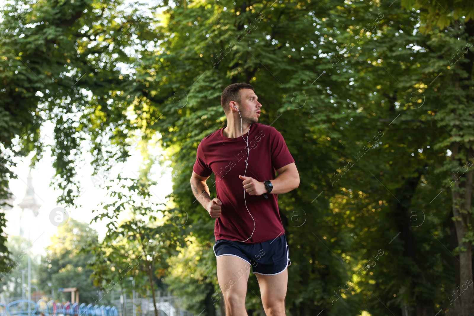 Athletic young man in sportswear running outdoors Photo of Athletic young man in sportswear running outdoors