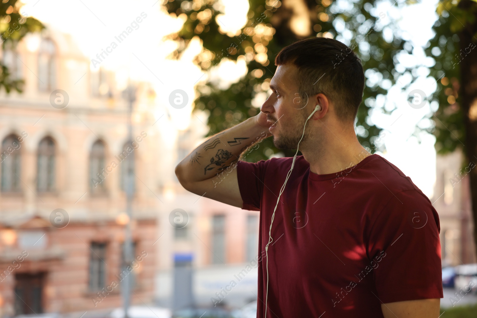 Athletic young man in sportswear before running outdoors, space for text Photo of Athletic young man in sportswear before running outdoors, space for text