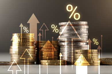 Image of Percent signs, arrows and stacked coins against grey background