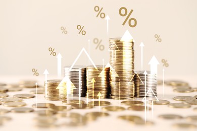 Image of Percent signs, arrows and stacked coins against beige background