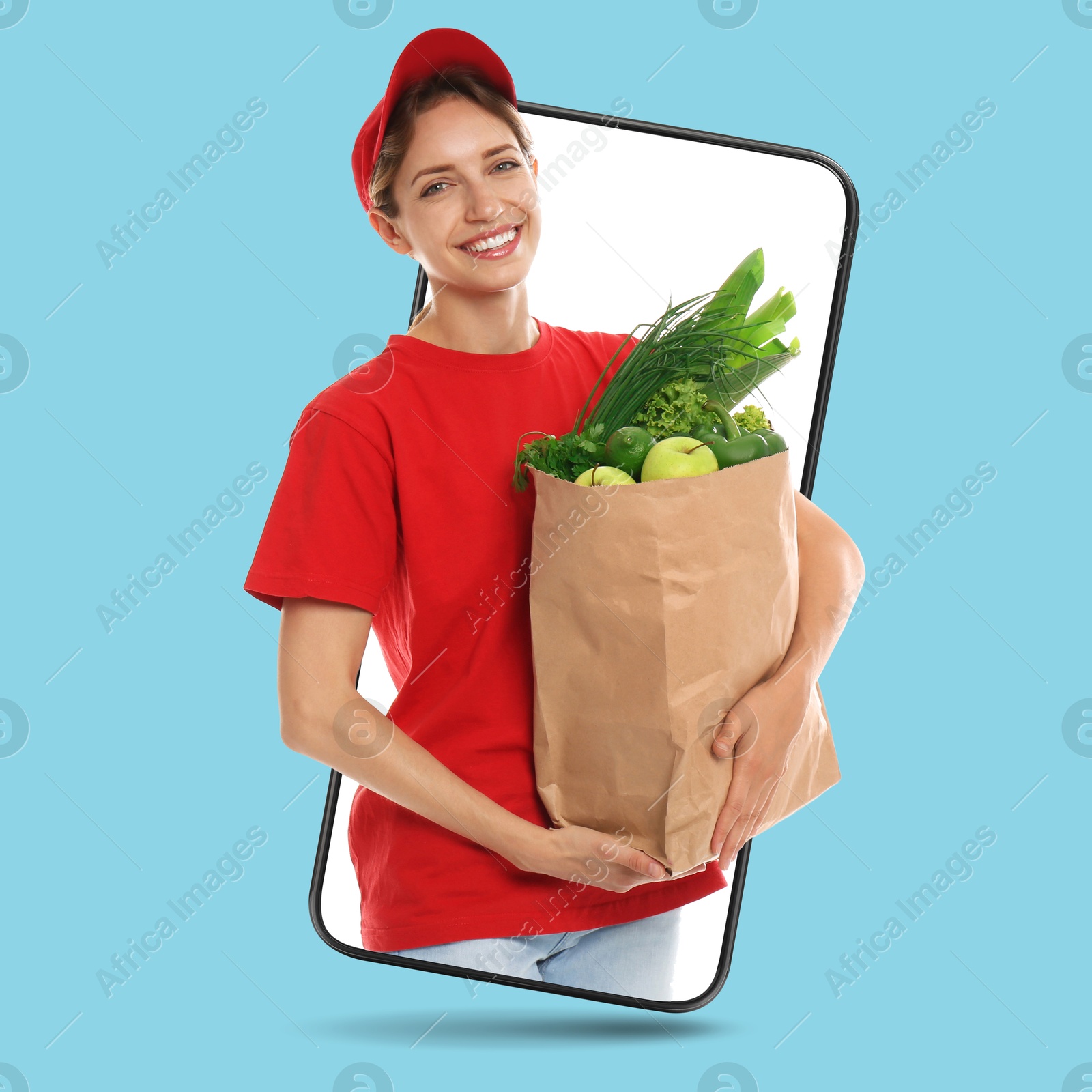 Delivery service worker giving order out of mobile phone against light blue background. Woman with paper bag full of food products Image of Delivery service worker giving order out of mobile phone against light blue background. Woman with paper bag full of food products
