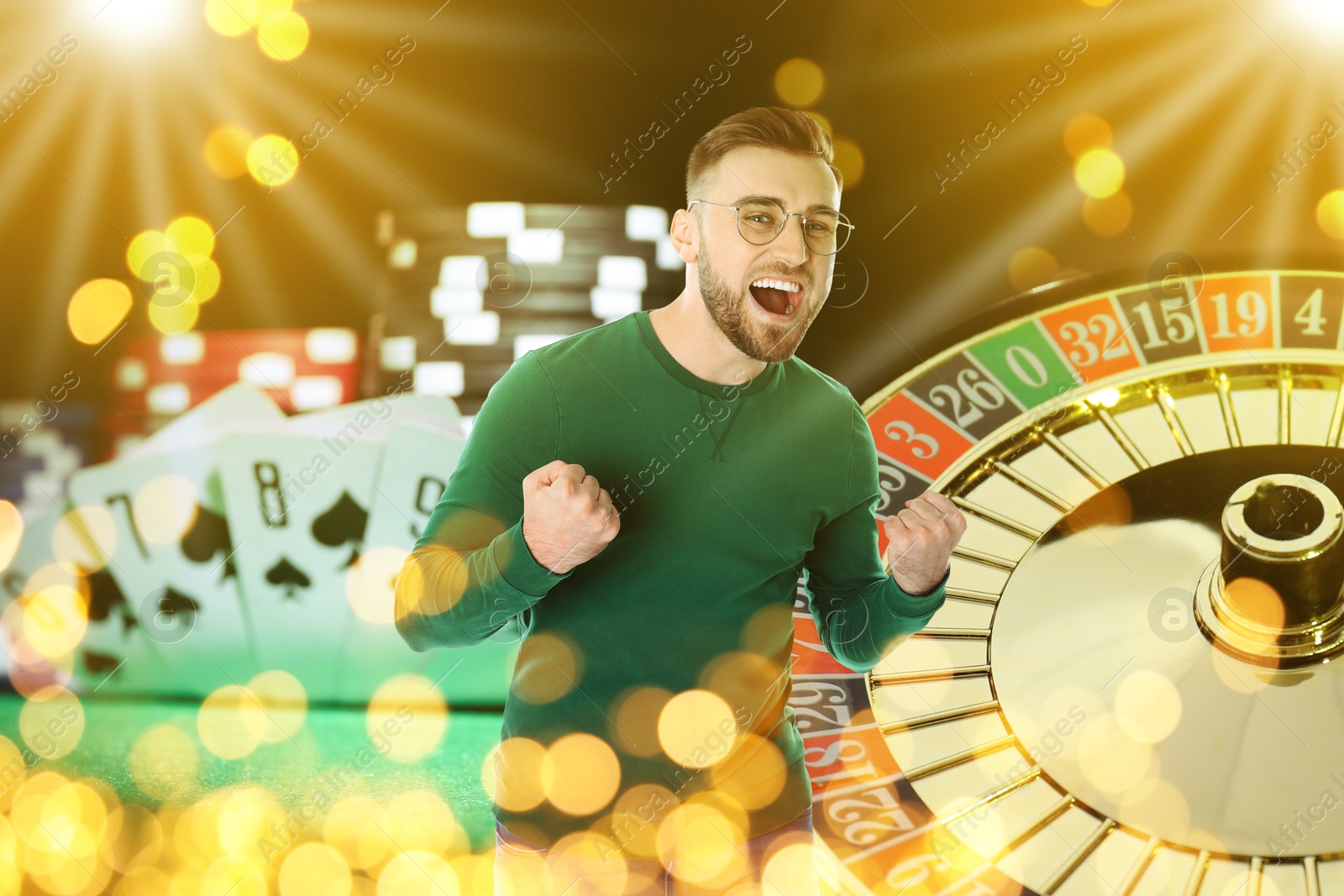 Happy gambler celebrating victory. Multiple exposure with casino chips, playing cards and roulette Image of Happy gambler celebrating victory. Multiple exposure with casino chips, playing cards and roulette