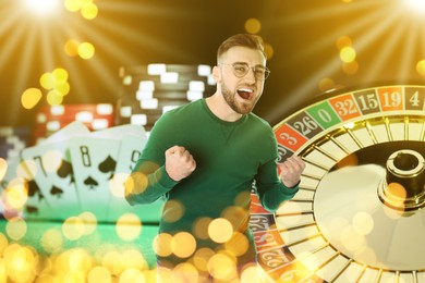 Image of Happy gambler celebrating victory. Multiple exposure with casino chips, playing cards and roulette