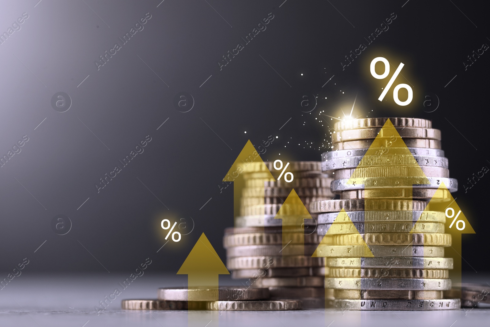 Coins with arrows and percent signs on table against grey background Image of Coins with arrows and percent signs on table against grey background