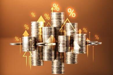Image of Percent signs, arrows and stacked coins on mirror surface against brown background