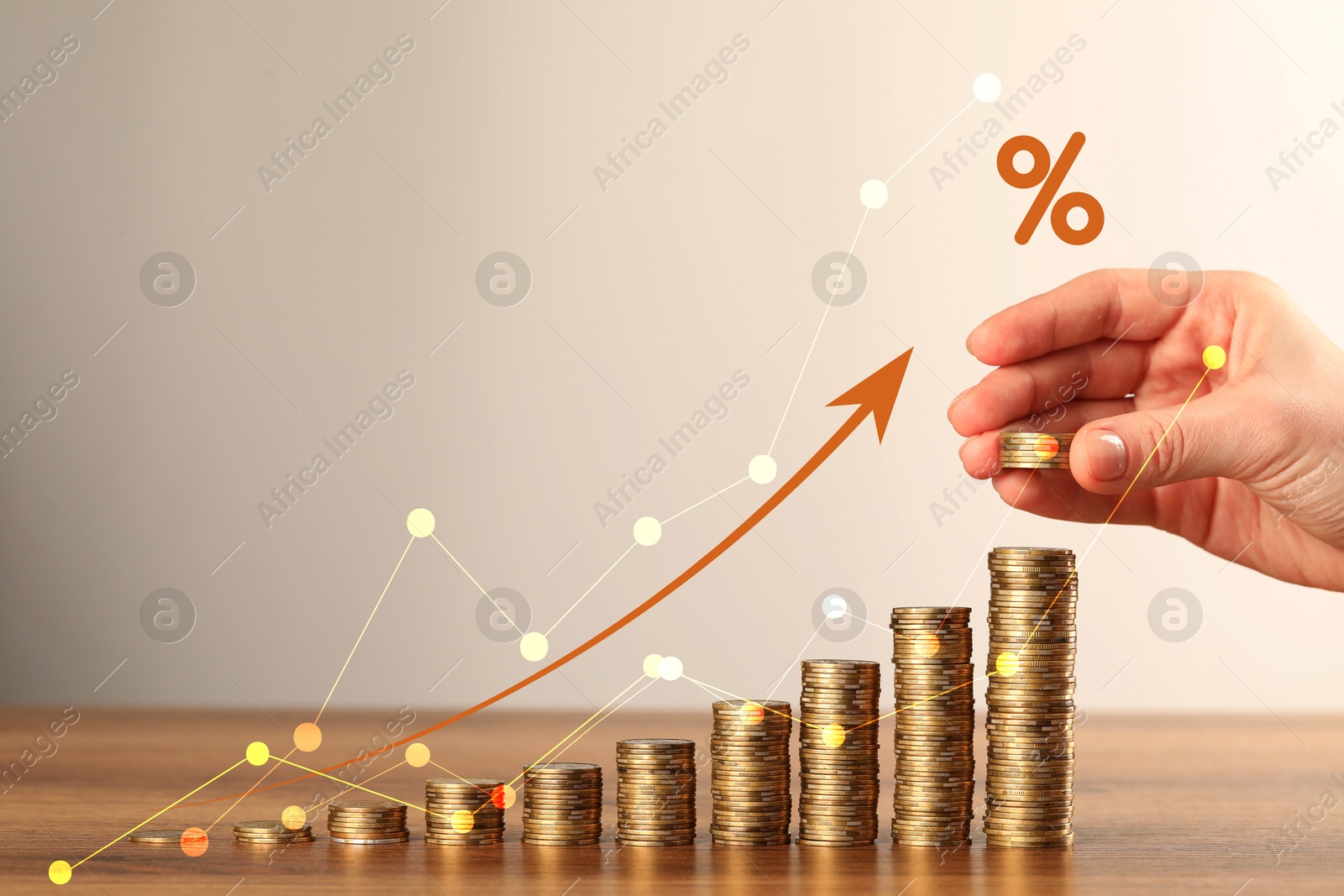 Image of Woman stacking coins at table, closeup. Graphs with percent sign and arrow above stacks