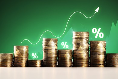 Image of Percent signs and arrow above stacked coins against green background