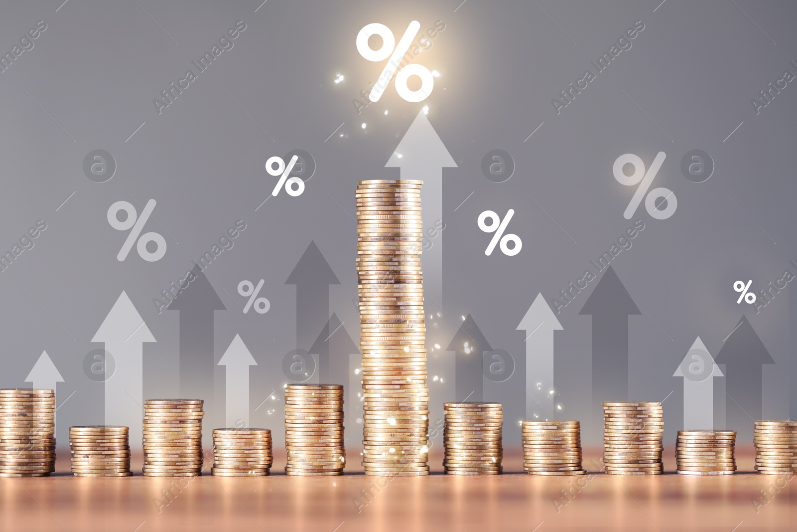 Percent signs, arrows and stacked coins against grey background Image of Percent signs, arrows and stacked coins against grey background