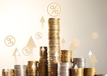 Image of Percent signs, arrows and stacked coins against beige background