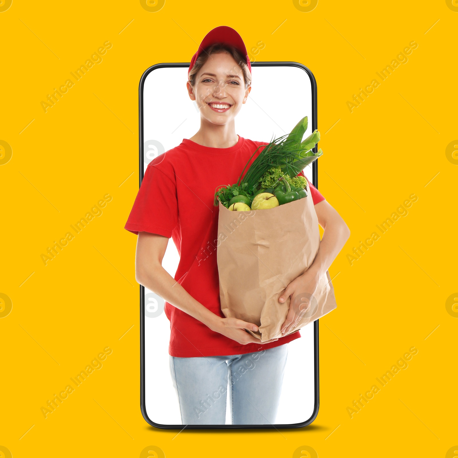 Delivery service worker giving order out of mobile phone against orange background. Woman with paper bag full of food products Image of Delivery service worker giving order out of mobile phone against orange background. Woman with paper bag full of food products