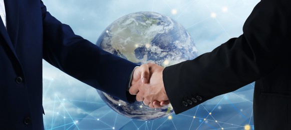 Image of Business people shaking hands against globe. Success in partnership, deal, agreement. Banner design
