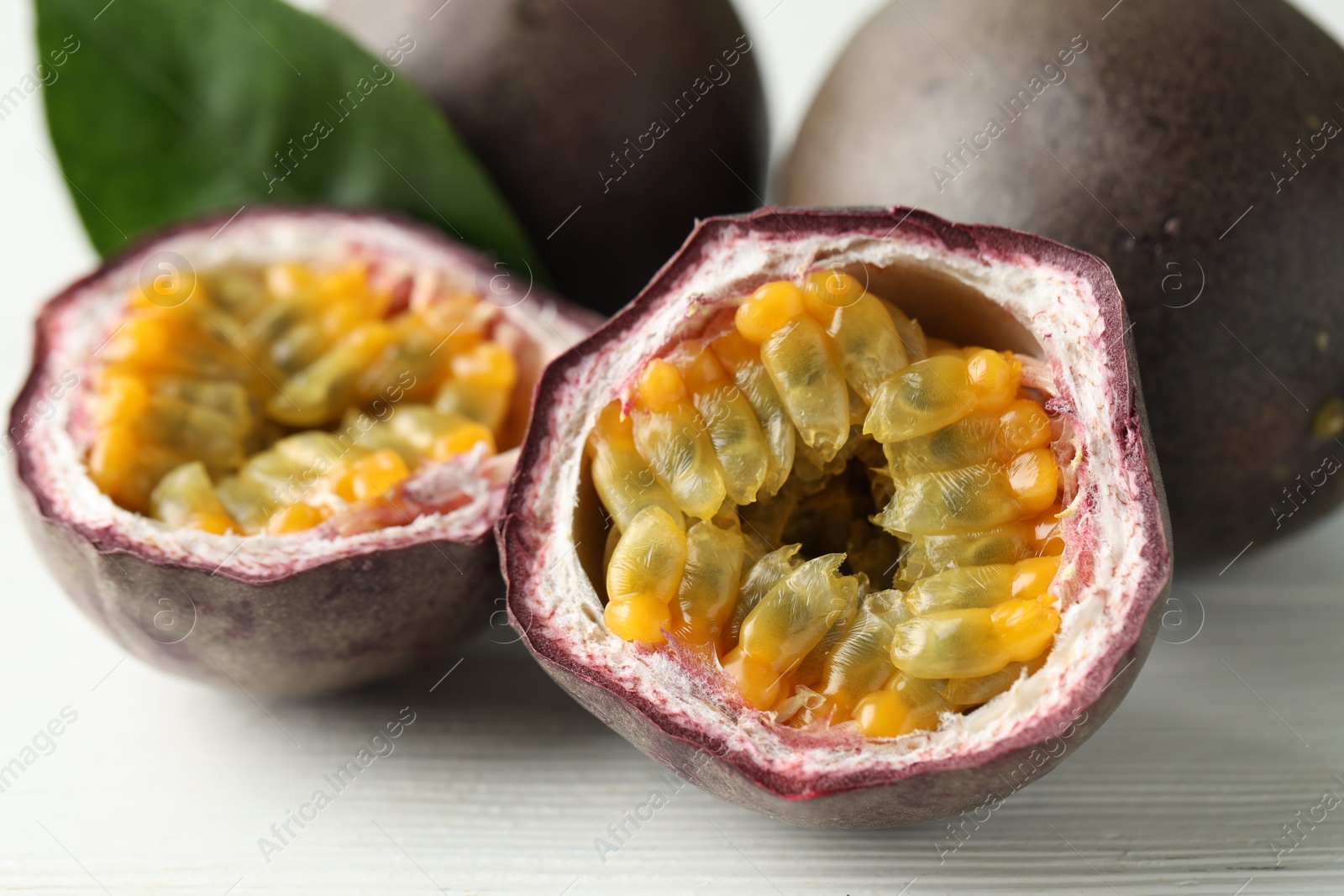 Fresh passion fruits on white wooden table, closeup Photo of Fresh passion fruits on white wooden table, closeup