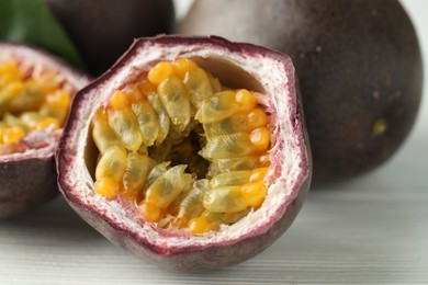 Photo of Fresh passion fruits on white wooden table, closeup