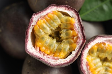 Photo of Fresh passion fruits and green leaf as background, top view