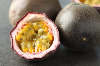 Photo of Fresh passion fruits on grey table, closeup