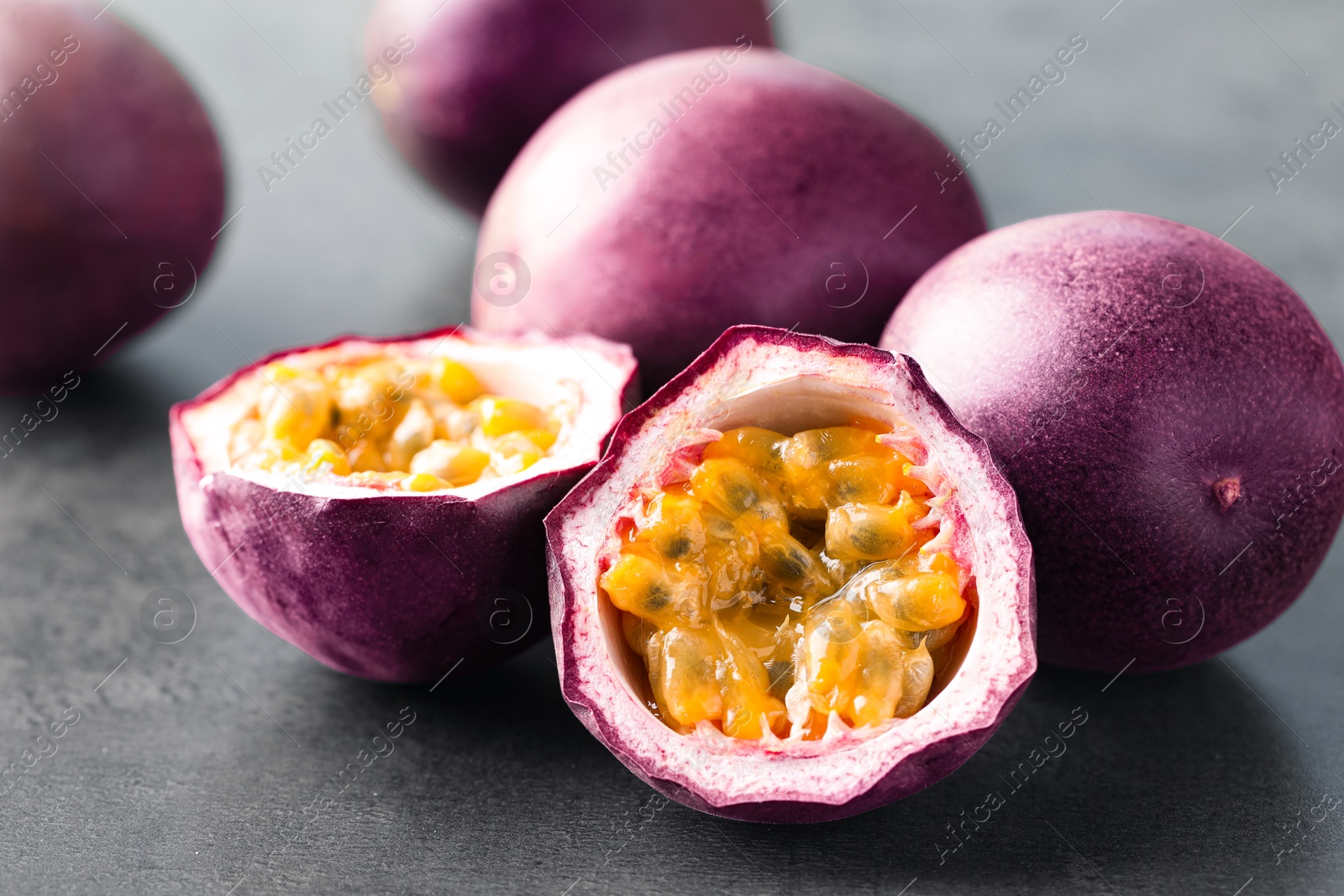 Fresh passion fruits on grey table, closeup Photo of Fresh passion fruits on grey table, closeup