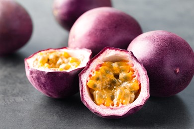 Photo of Fresh passion fruits on grey table, closeup