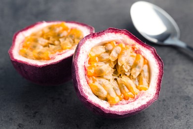 Photo of Fresh passion fruits on grey table, closeup