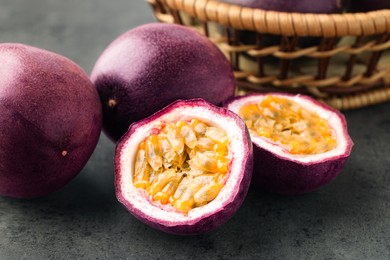 Photo of Fresh passion fruits on grey table, closeup