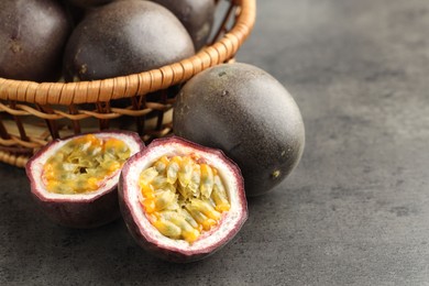 Photo of Fresh passion fruits on grey table, closeup. Space for text