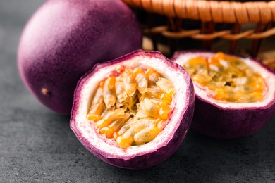 Photo of Fresh passion fruits on grey table, closeup