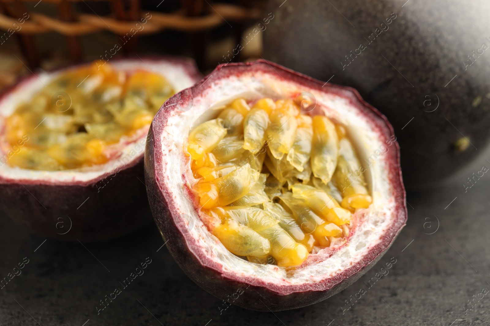 Fresh passion fruits on grey table, closeup Photo of Fresh passion fruits on grey table, closeup