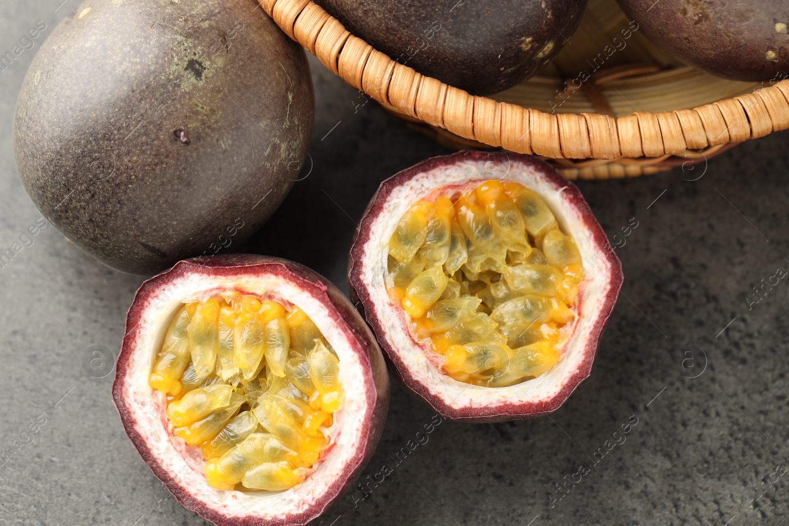 Fresh passion fruits on grey table, flat lay Photo of Fresh passion fruits on grey table, flat lay
