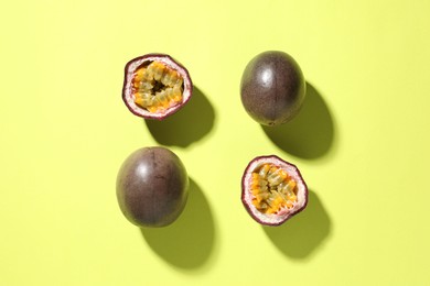 Photo of Fresh passion fruits on pale green background, flat lay