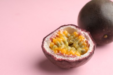 Photo of Fresh passion fruits on pink background, closeup. Space for text