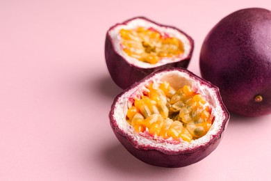 Photo of Fresh passion fruits on pink background, closeup. Space for text