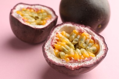 Photo of Fresh passion fruits on pink background, closeup