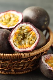 Photo of Fresh passion fruits on grey table, closeup