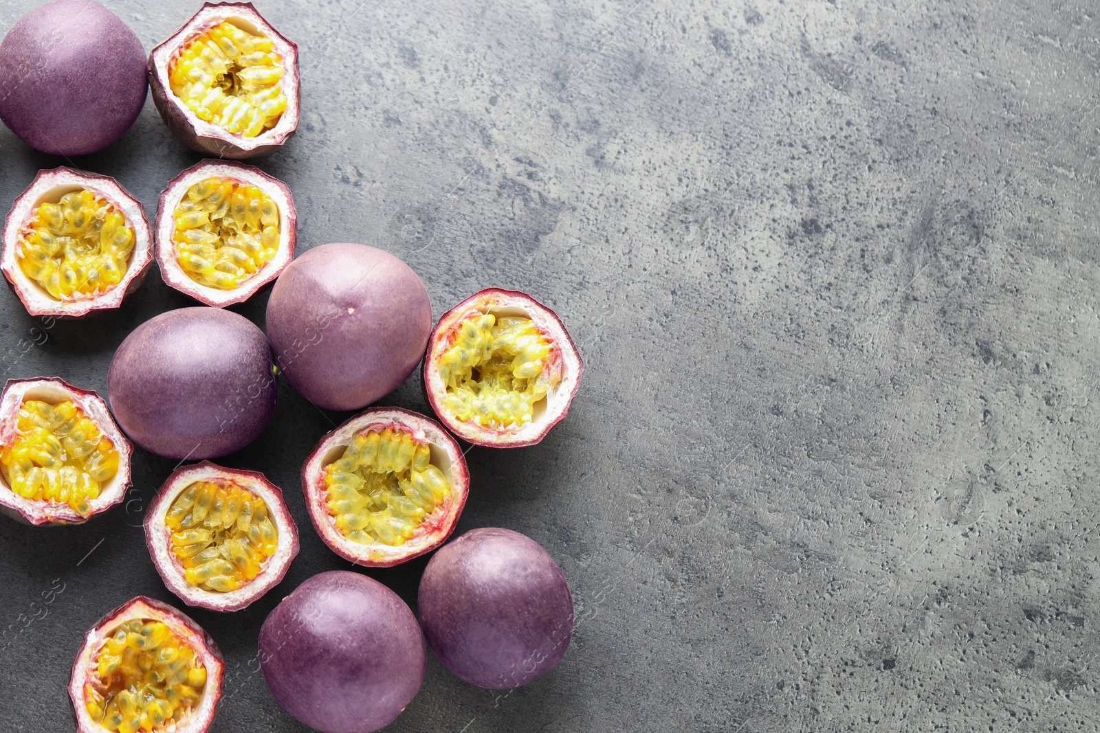 Photo of Fresh passion fruits on grey table, flat lay. Space for text