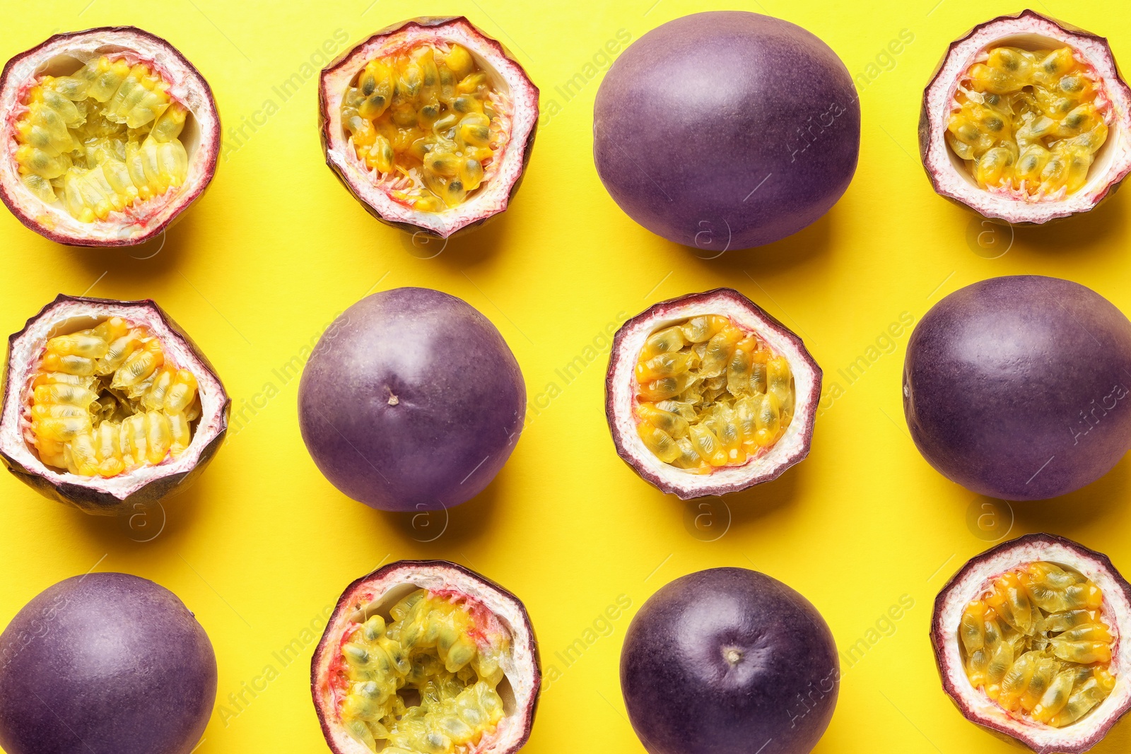 Photo of Fresh passion fruits on yellow background, flat lay