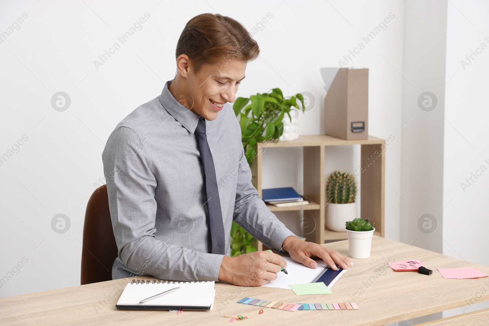 Business planning. Man with calendar at wooden table in office Photo of Business planning. Man with calendar at wooden table in office