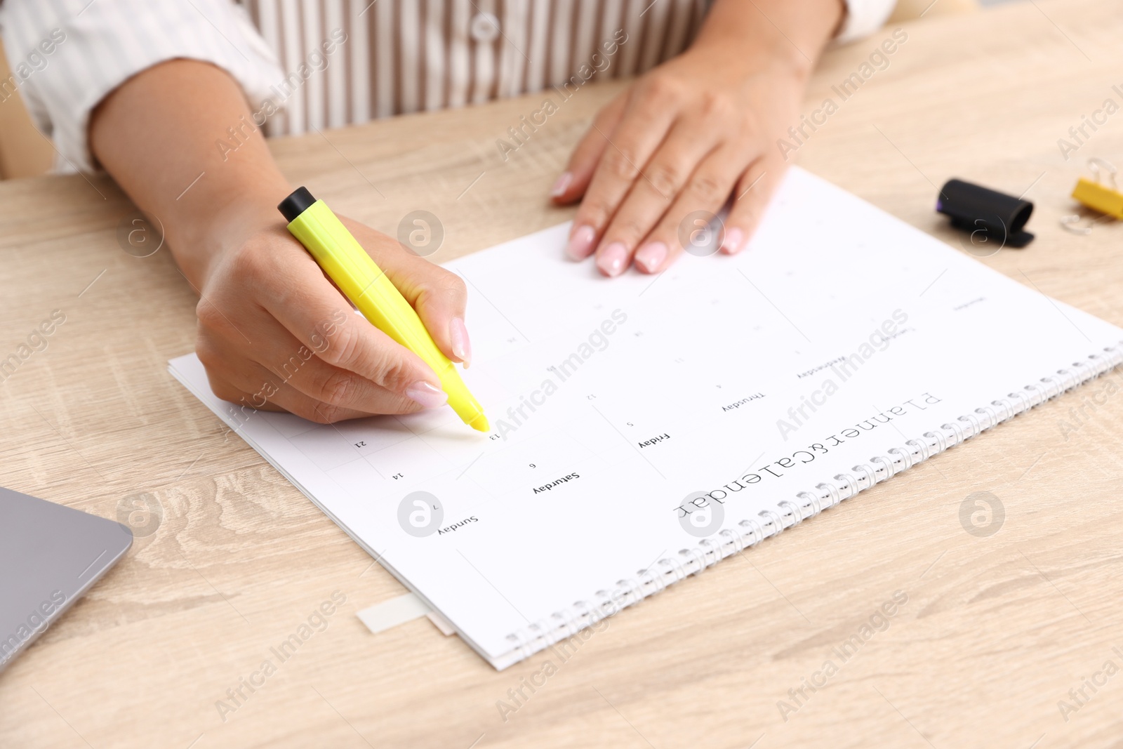 Business planning. Woman with calendar at wooden table in office, closeup Photo of Business planning. Woman with calendar at wooden table in office, closeup