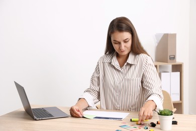 Photo of Business planning. Woman with calendar at wooden table in office