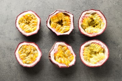 Photo of Fresh passion fruits on grey table, flat lay