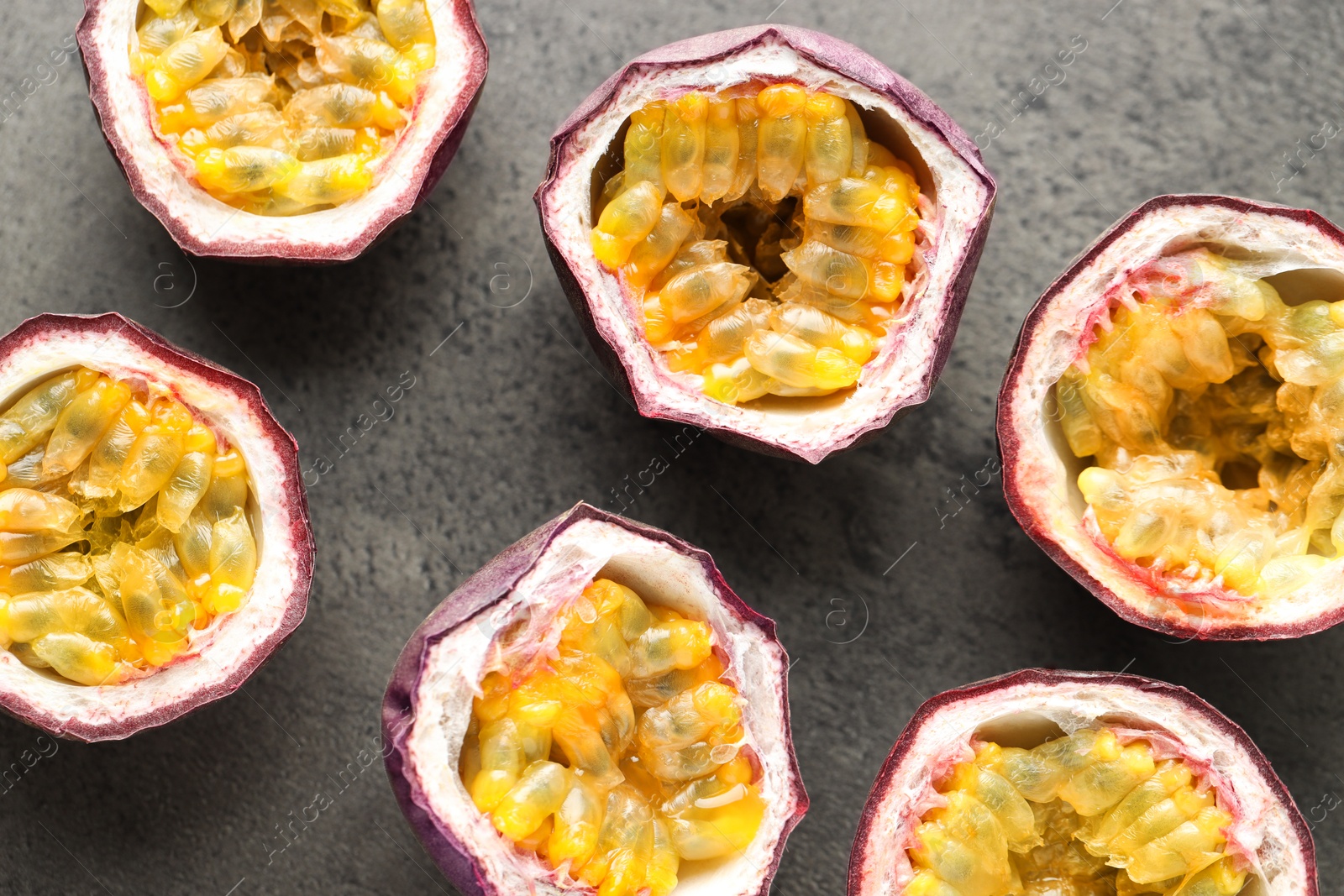 Photo of Fresh passion fruits on grey table, flat lay