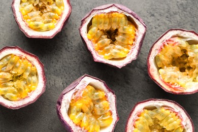 Photo of Fresh passion fruits on grey table, flat lay