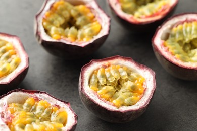 Photo of Fresh passion fruits on grey table, closeup