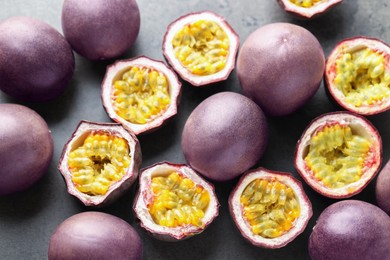 Photo of Fresh passion fruits on grey table, flat lay