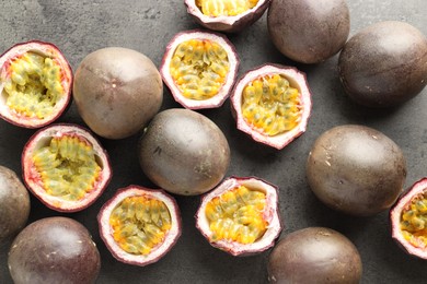 Photo of Fresh passion fruits on grey table, flat lay
