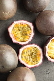 Photo of Fresh passion fruits on grey table, flat lay