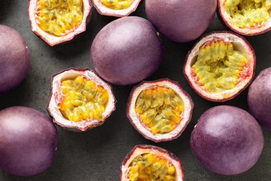 Photo of Fresh passion fruits on grey table, flat lay